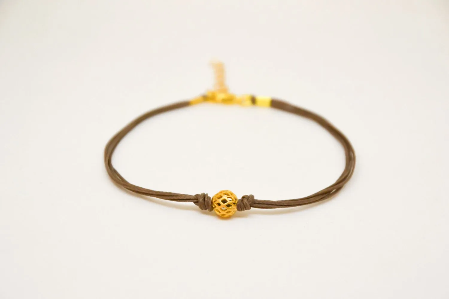 Brown ankle bracelet with matt gold ball bead charm