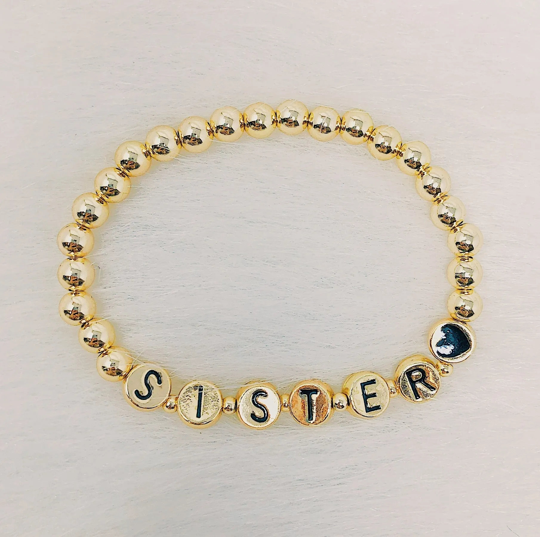 Gold Tone Ball Bead Bracelet With Black Stamped Letter Beads
