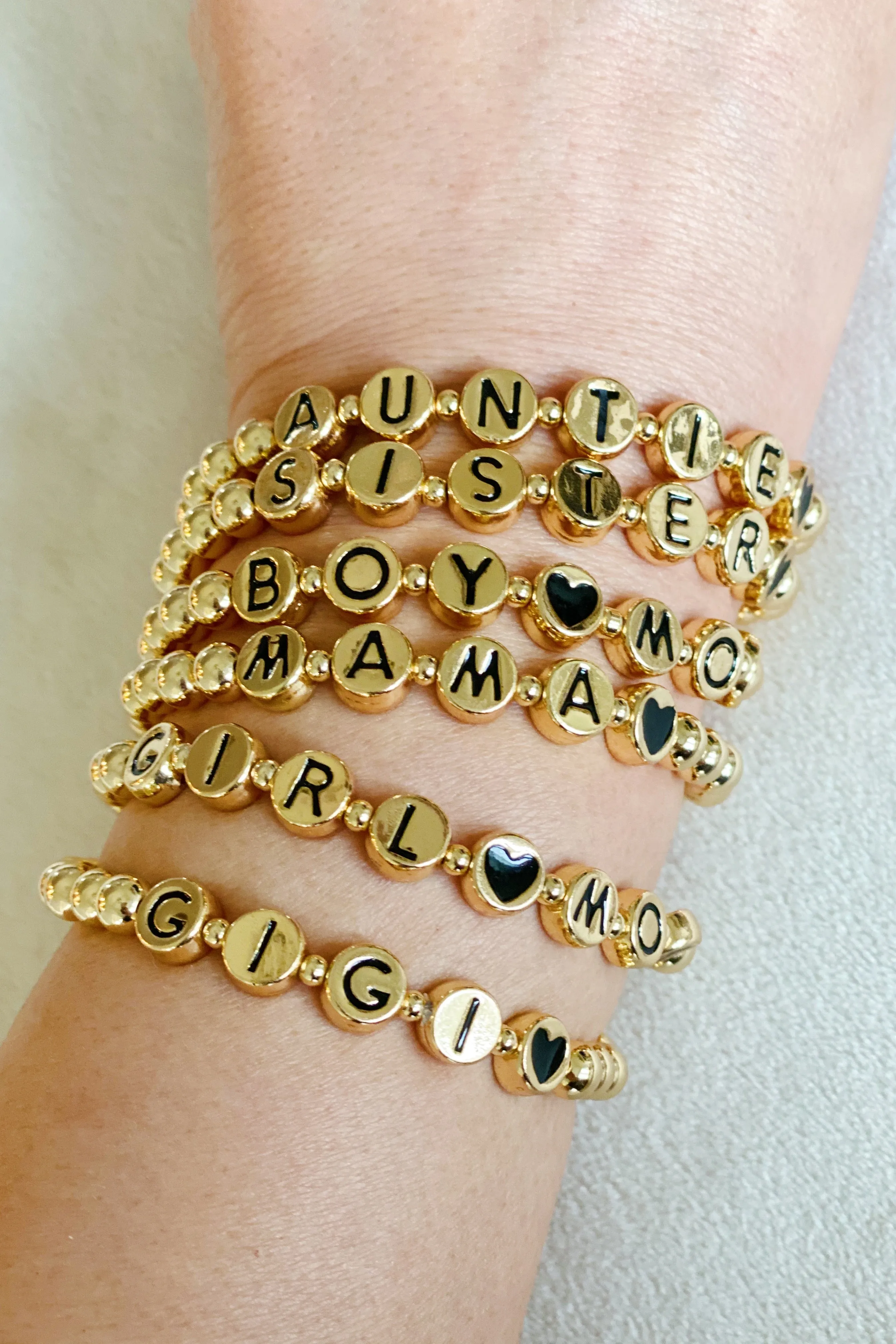 Gold Tone Ball Bead Bracelet With Black Stamped Letter Beads