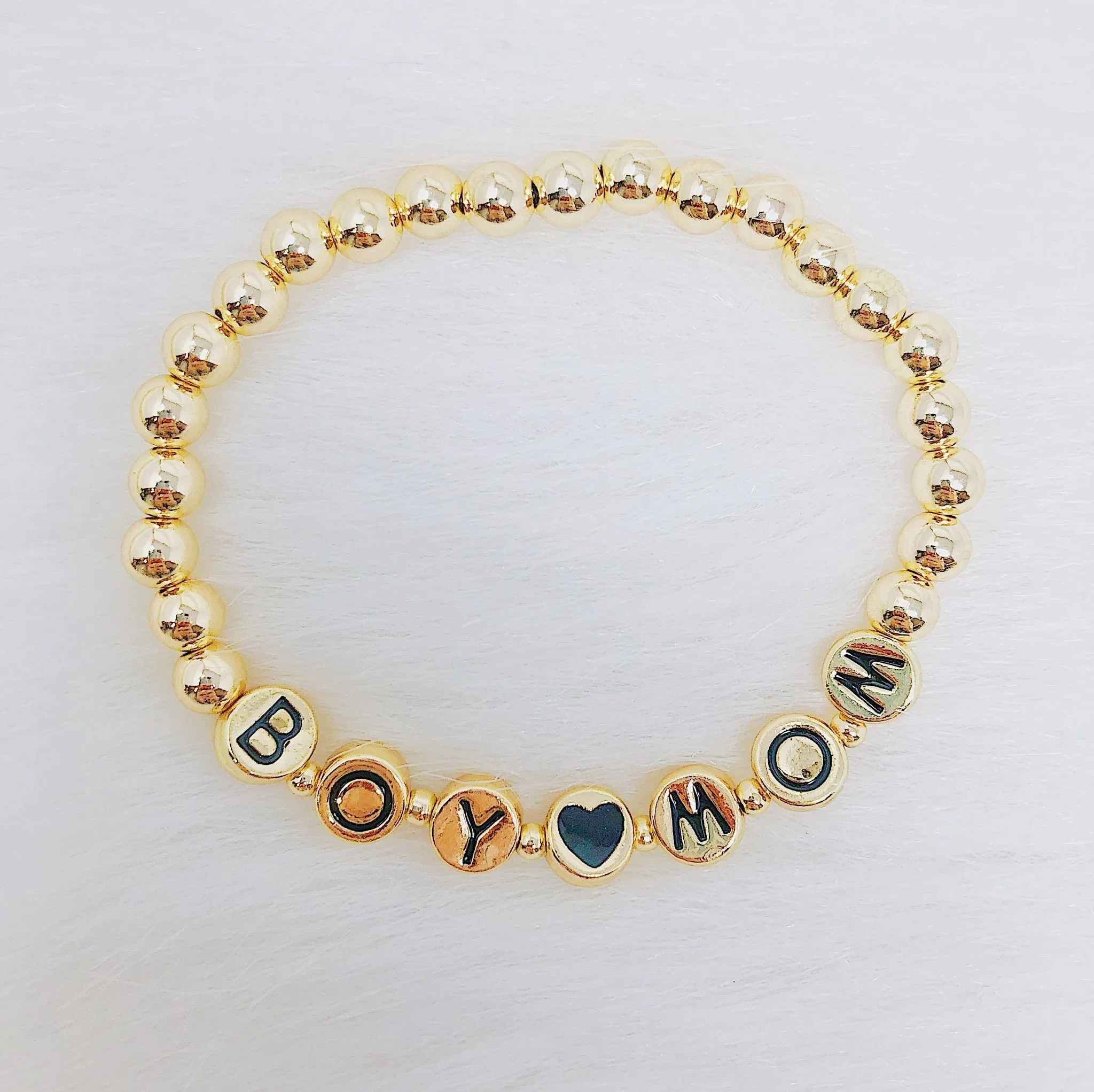 Gold Tone Ball Bead Bracelet With Black Stamped Letter Beads
