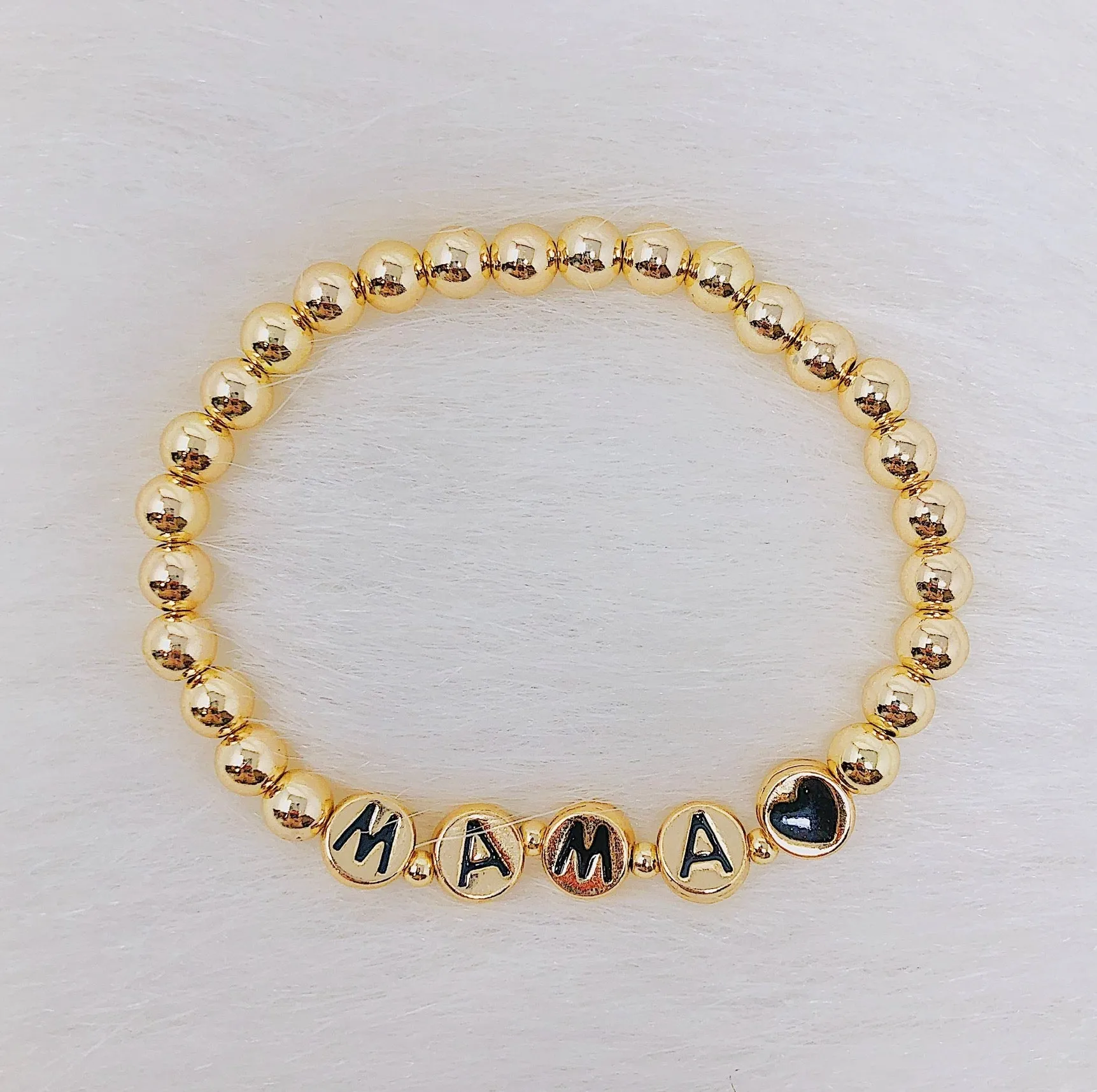 Gold Tone Ball Bead Bracelet With Black Stamped Letter Beads