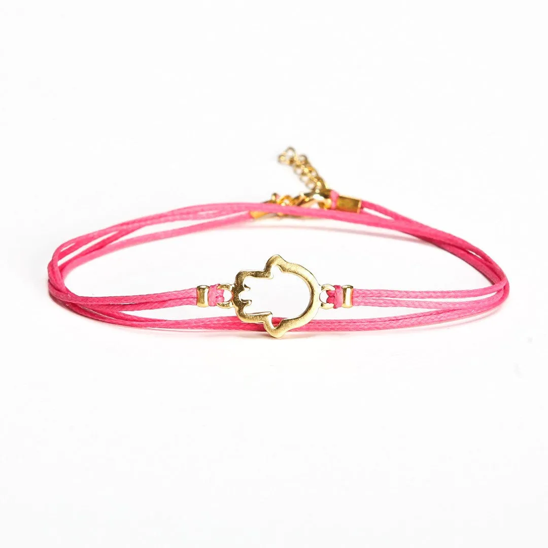 Pink wrapped cord anklet with gold Hamsa charm, evil eye protection