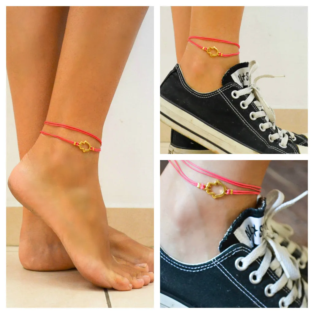 Pink wrapped cord anklet with gold Hamsa charm, evil eye protection