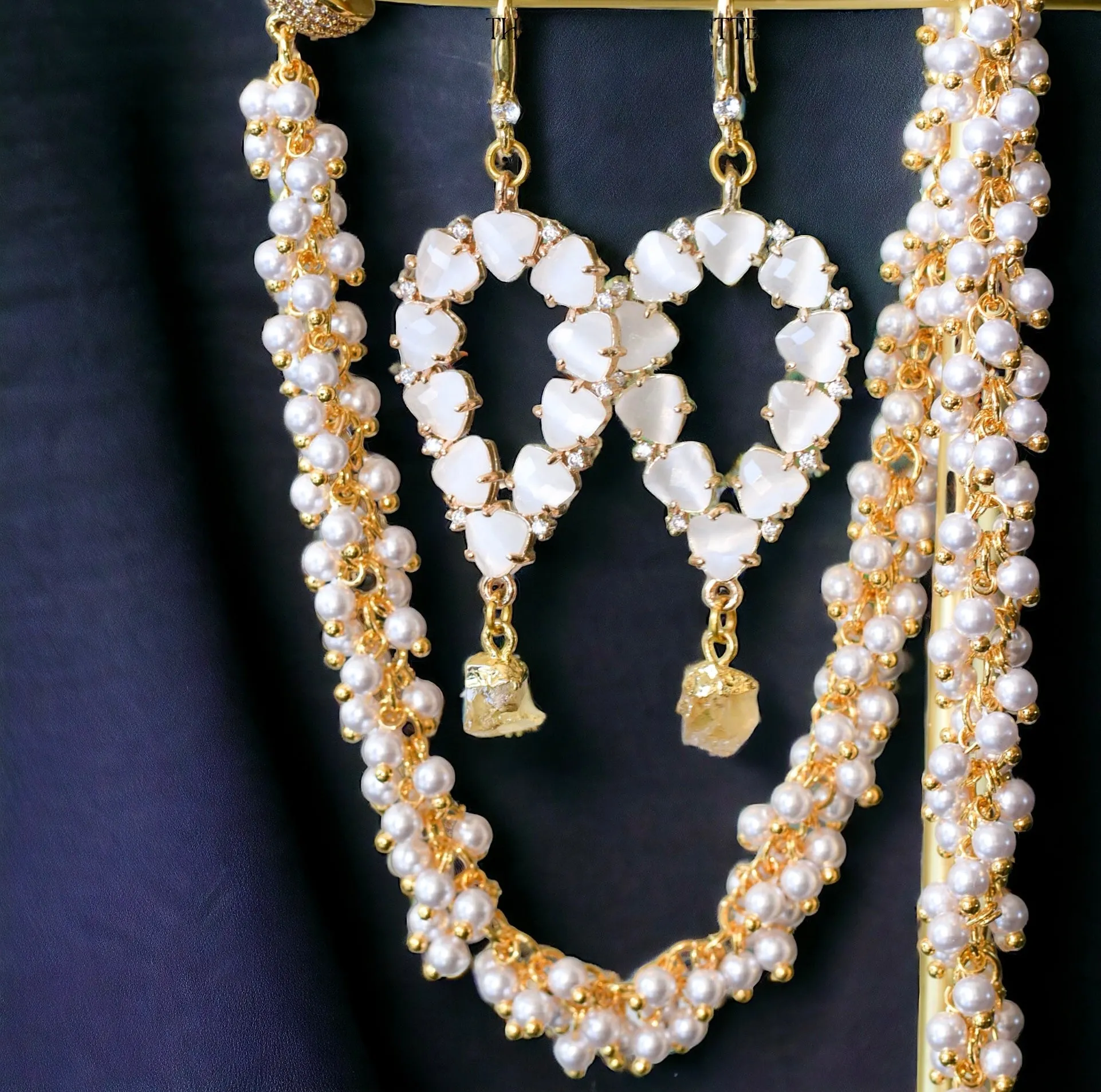 Yara white stones with gold edged ruby drop earrings